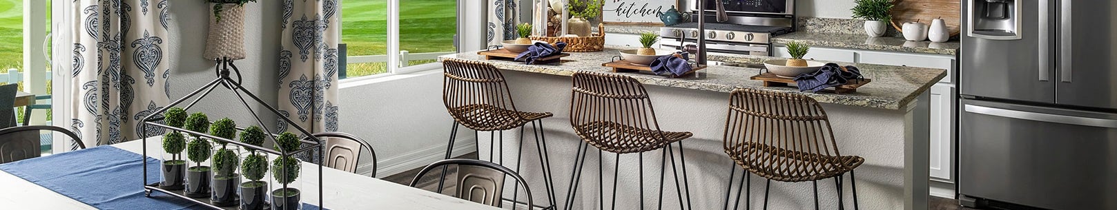 A kitchen with a table and chairs.