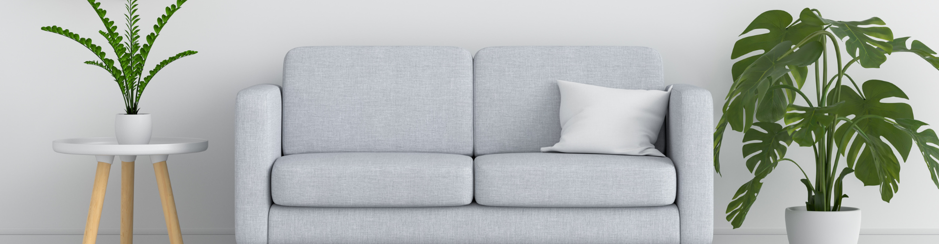 A grey couch with potted plants.