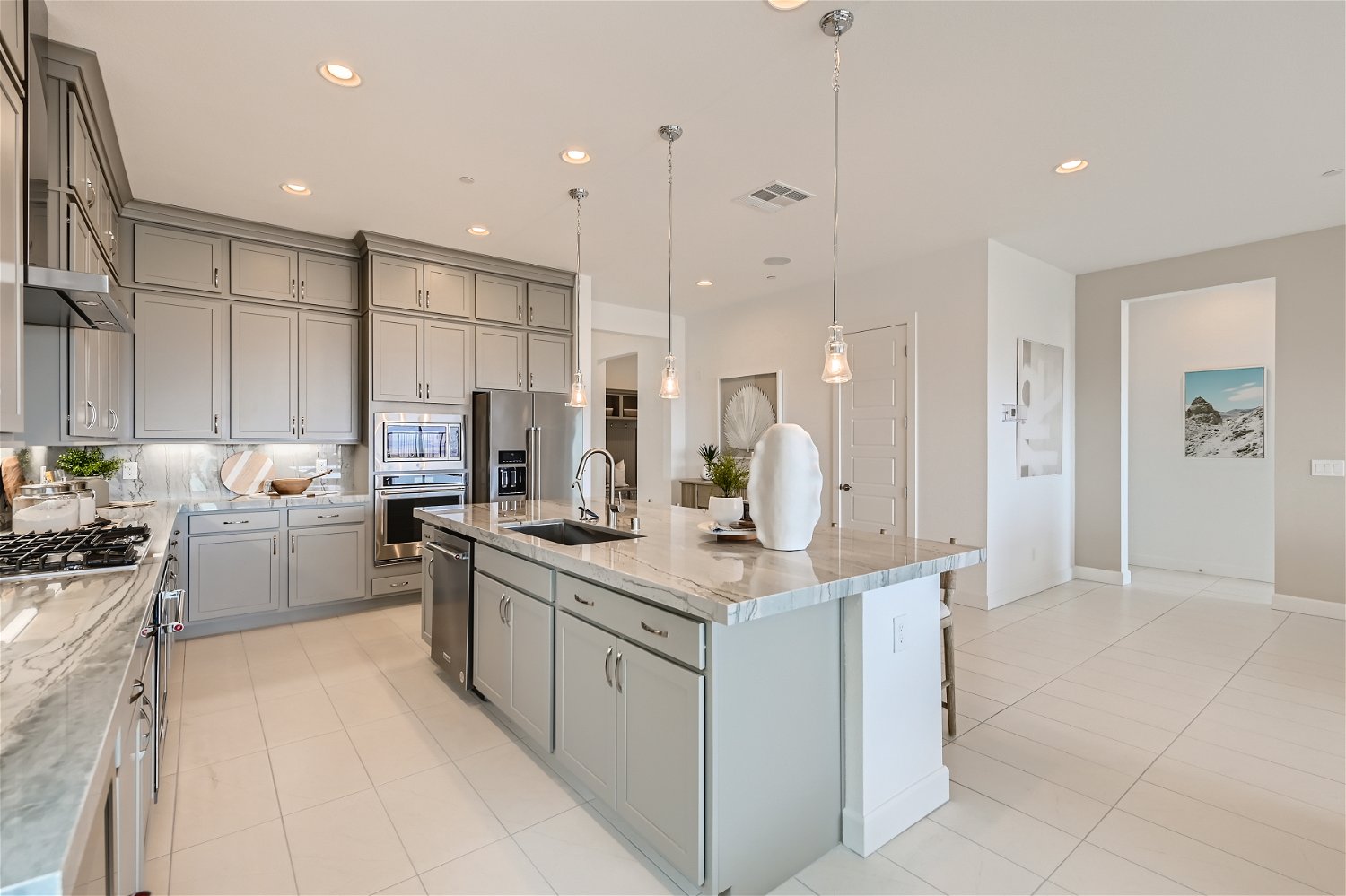 A kitchen with white cabinets.