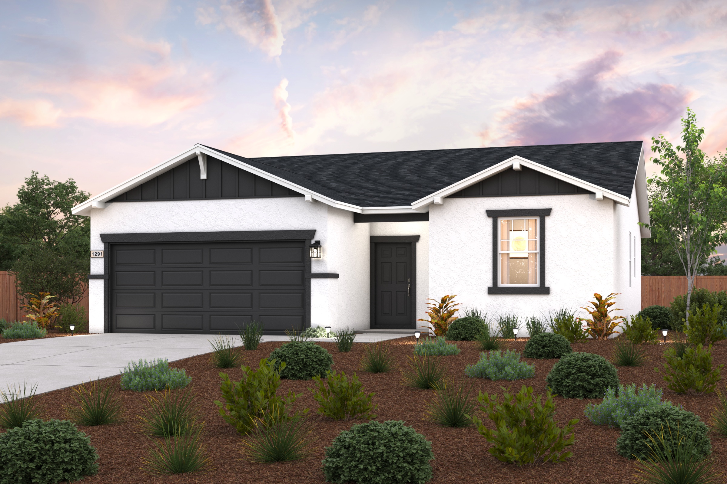 A house with a garage and bushes in front of it.