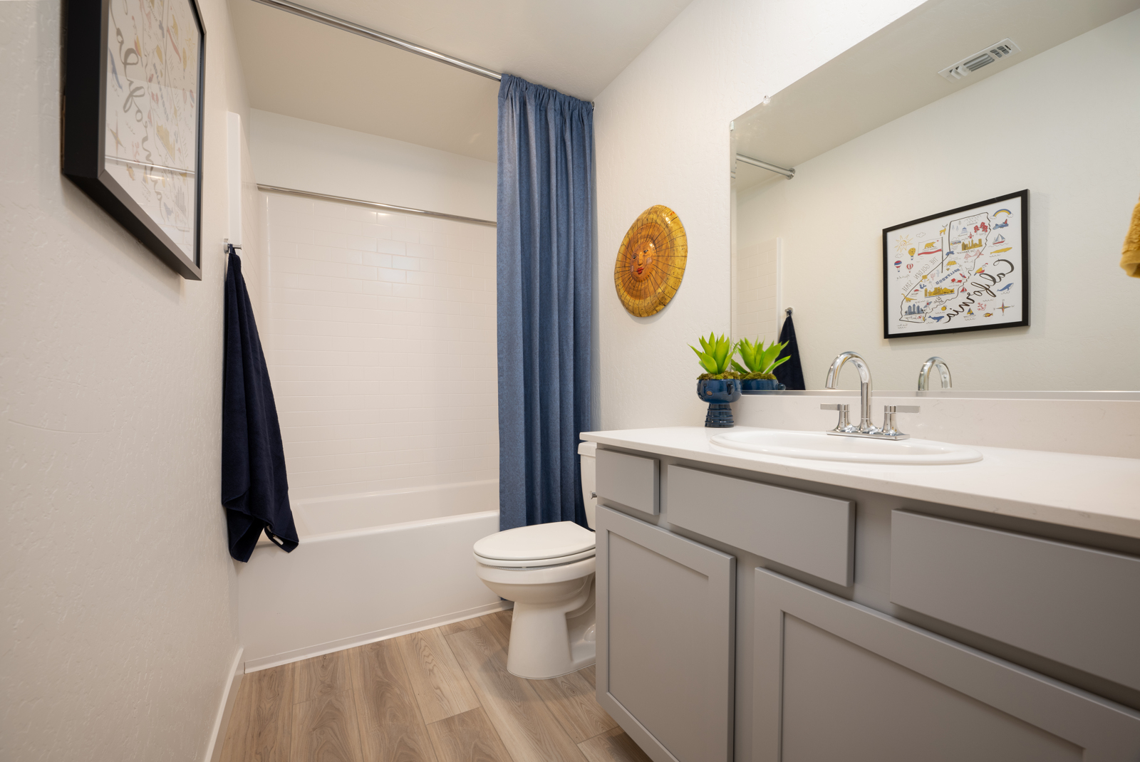 A bathroom with a sink toilet and a bathtub.