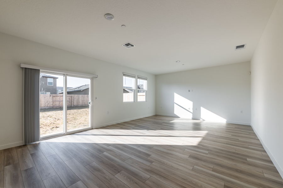 A room with a wood floor and windows.