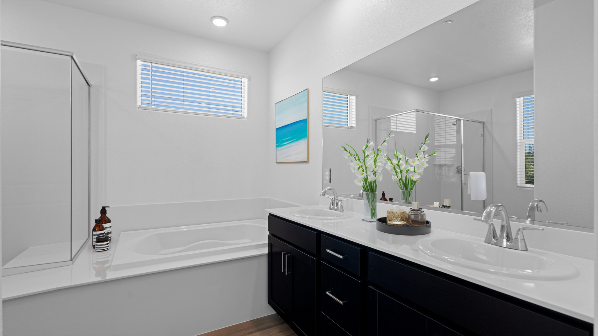 A bathroom with a tub sink and a mirror.