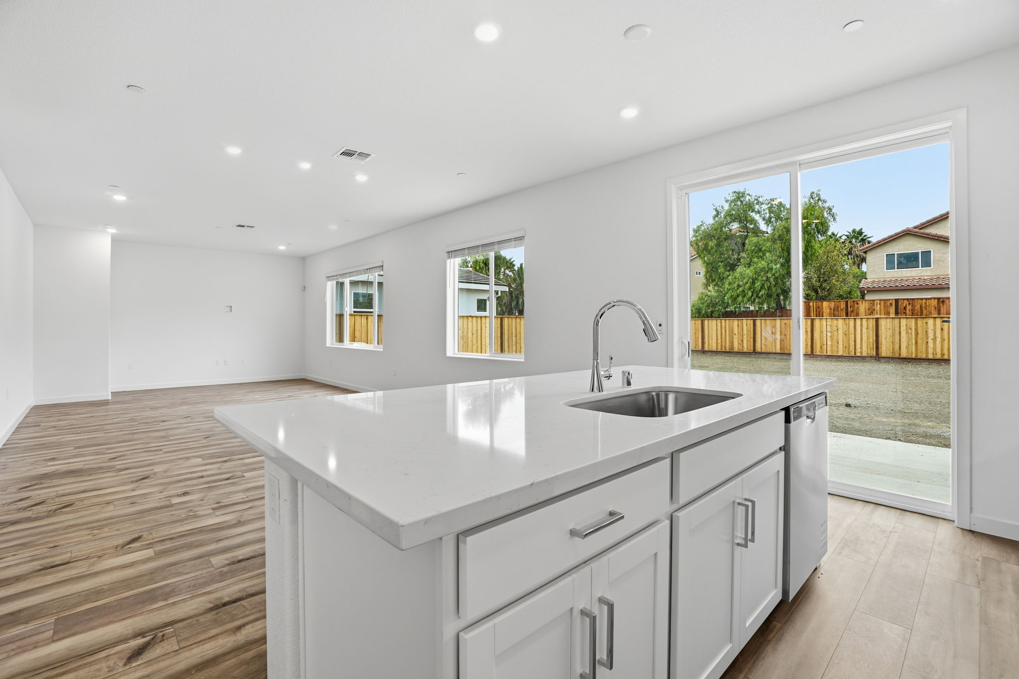 A kitchen with a large window.