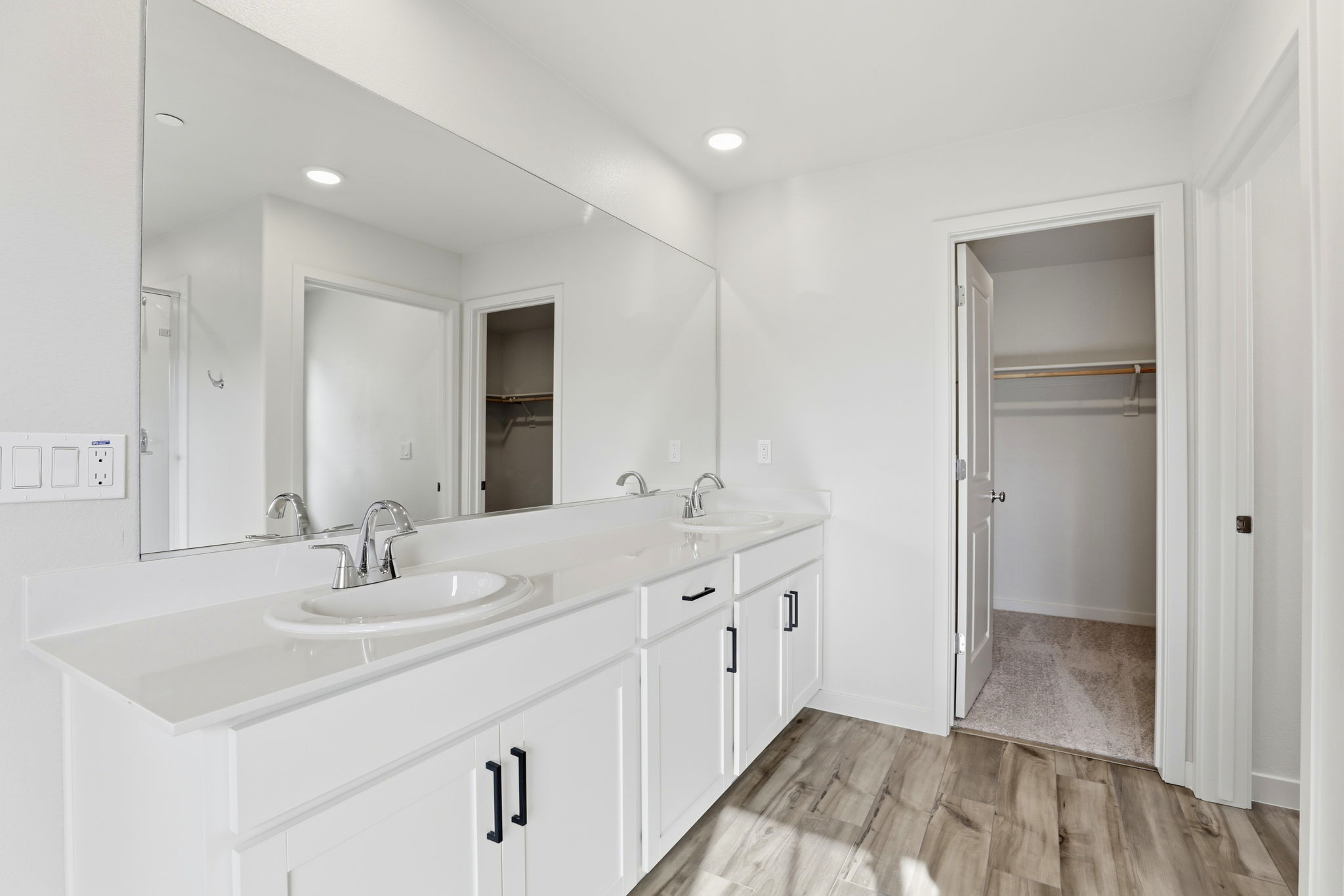 A bathroom with a large mirror.