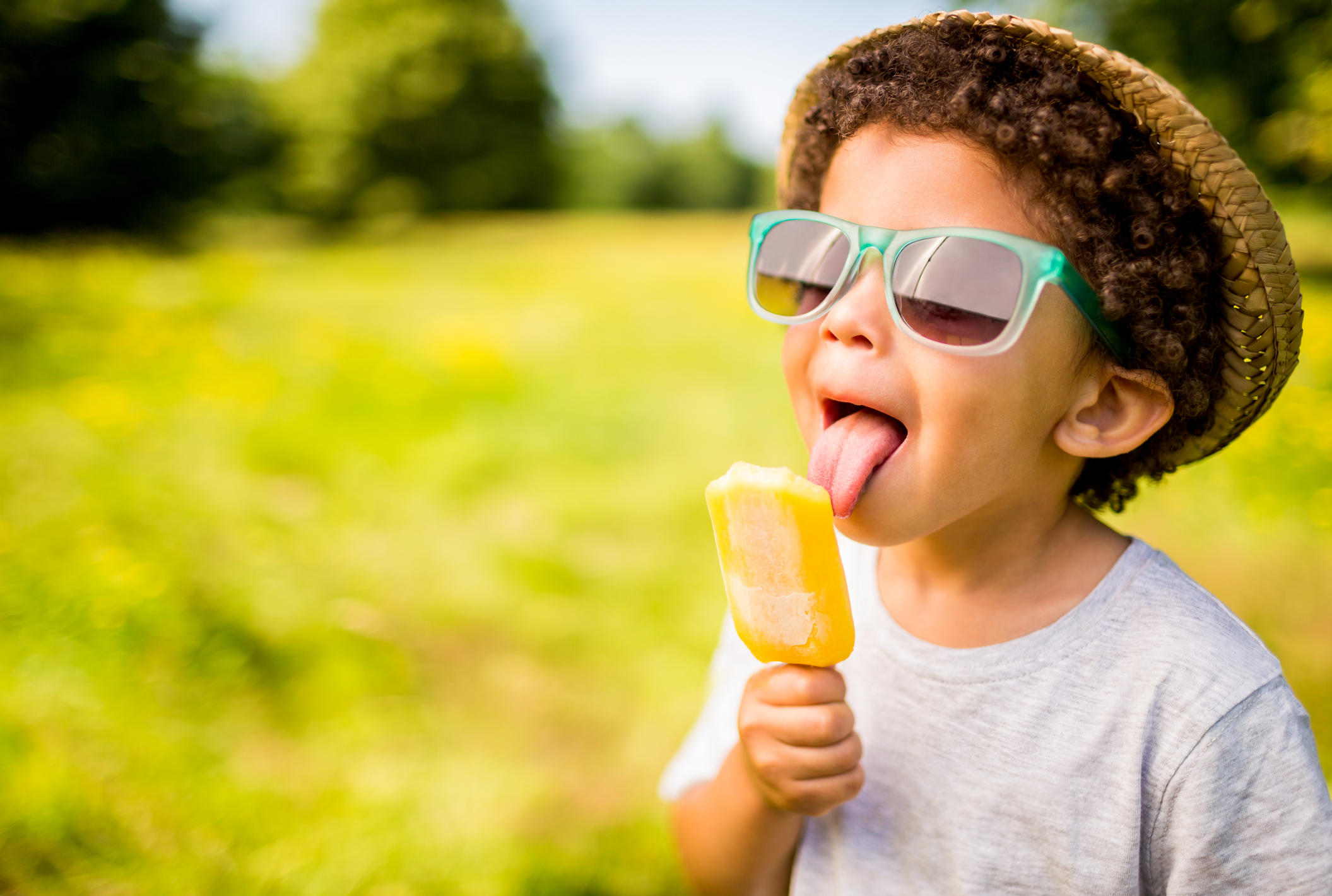 A boy eating an ice cream cone.