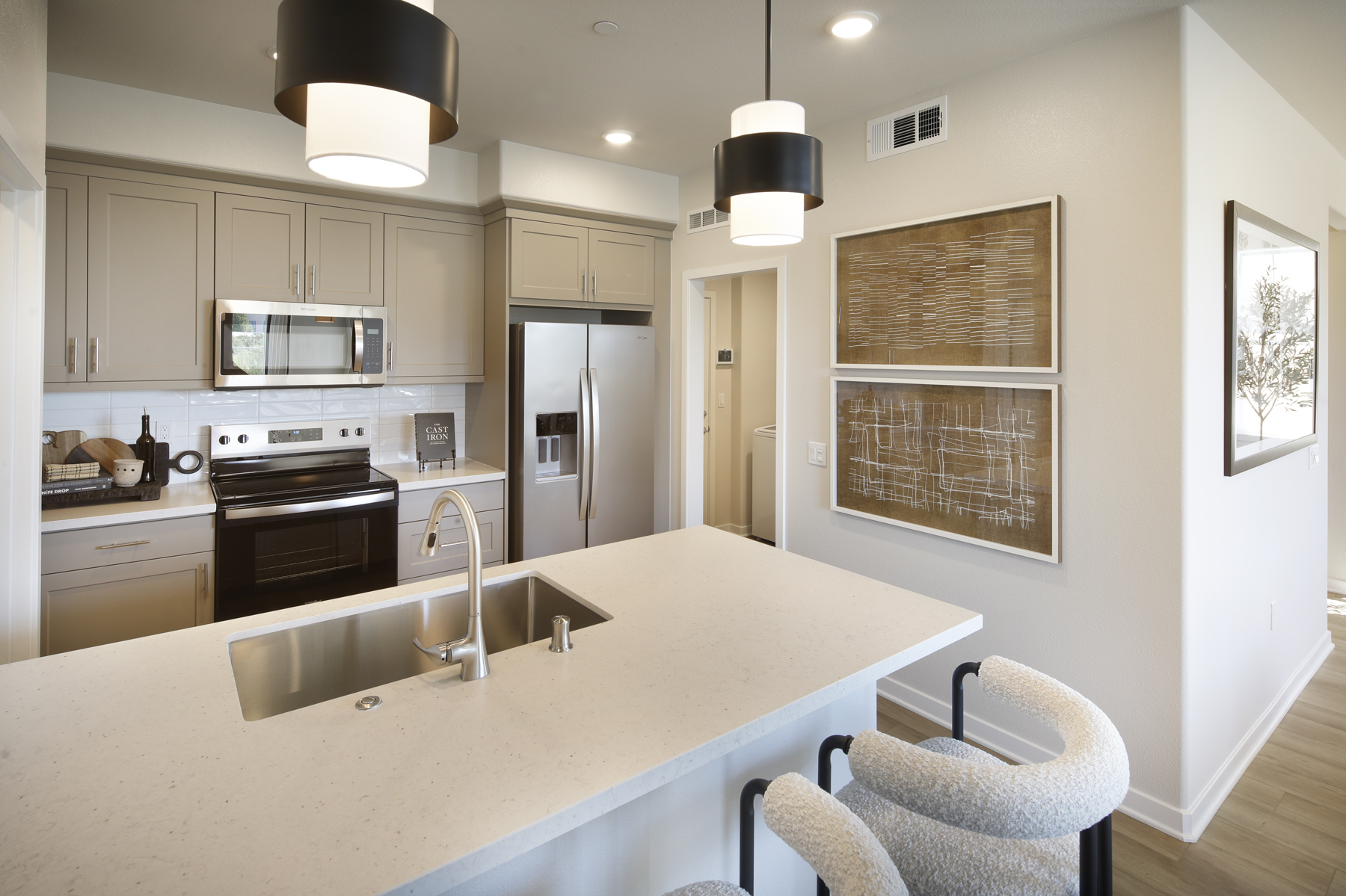 A kitchen with white cabinets.