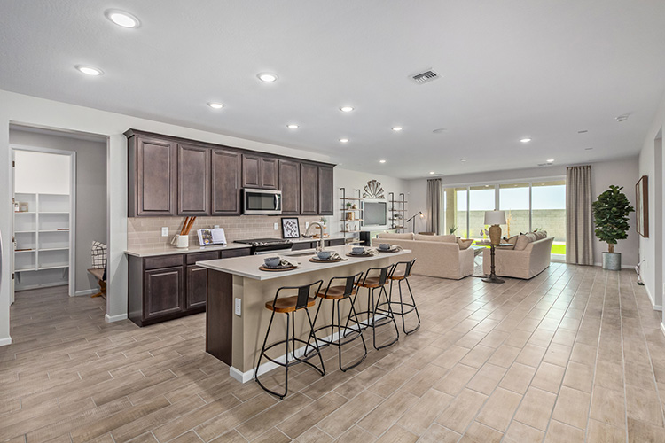 A large kitchen with a dining table.