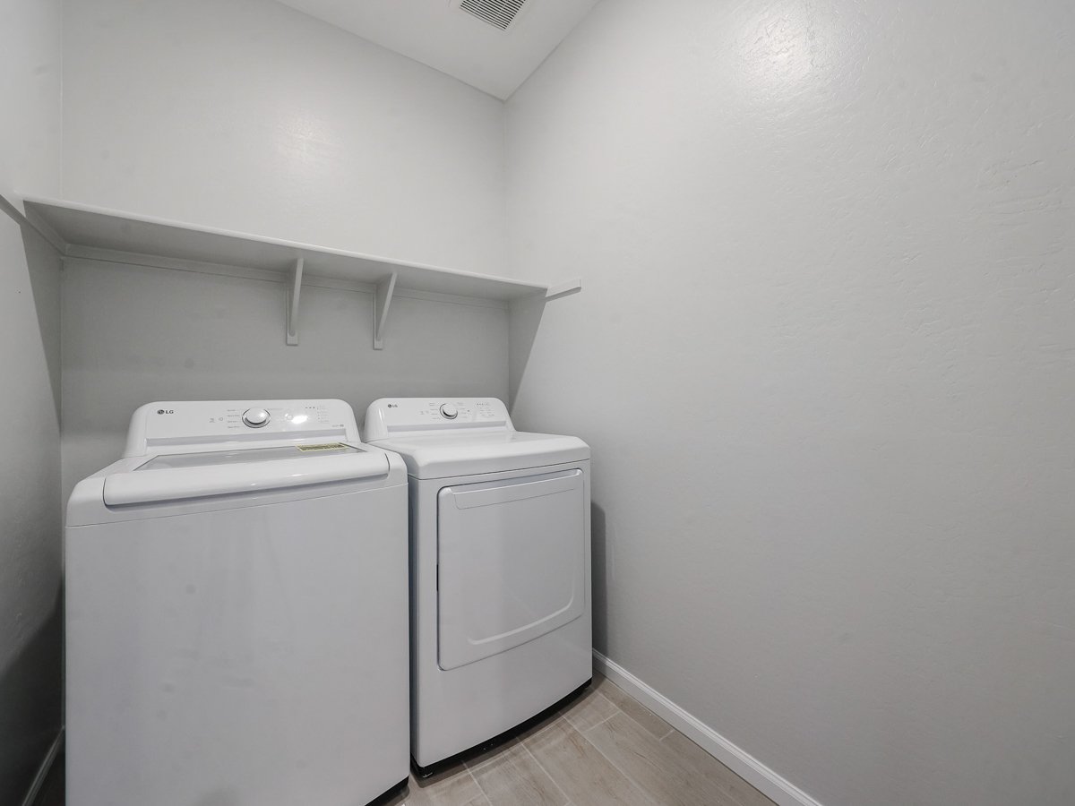 A washing machine in a room.