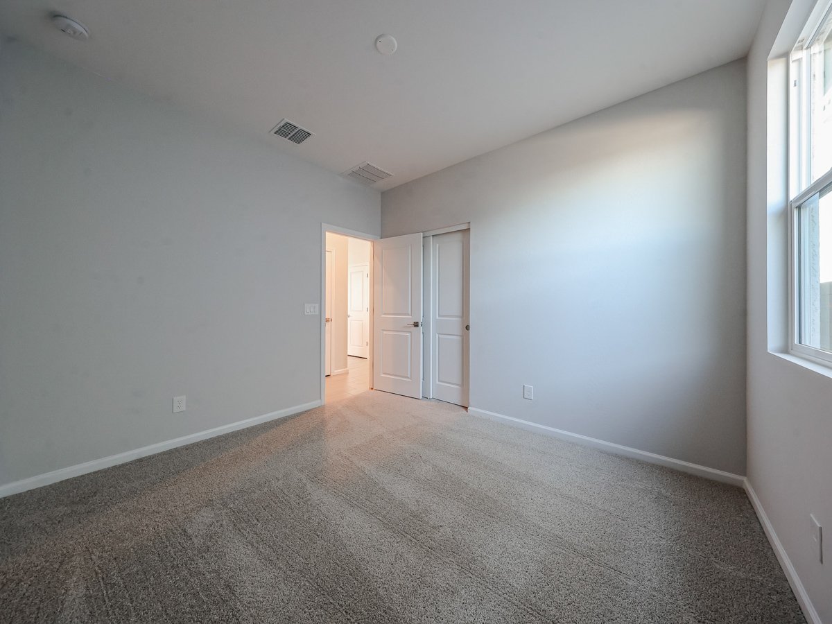 A room with white walls and a carpeted floor.