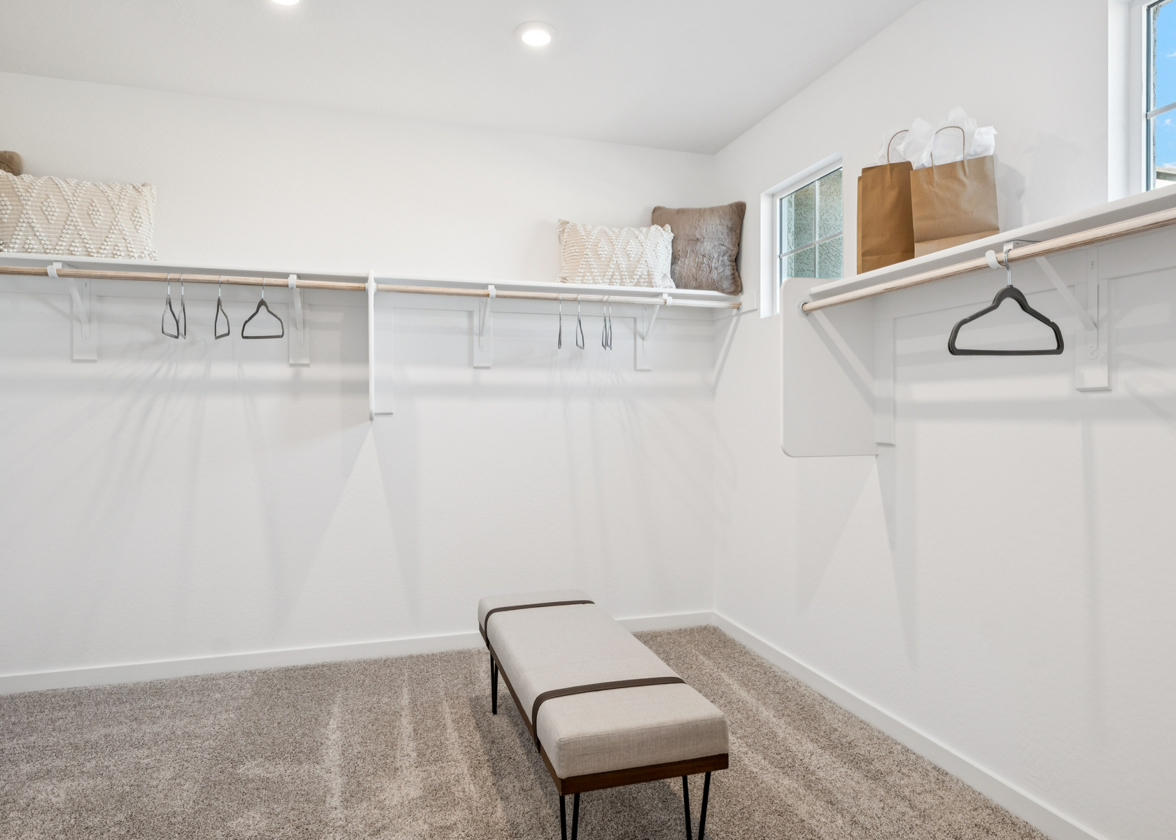 A white room with a white wall and a white bed.