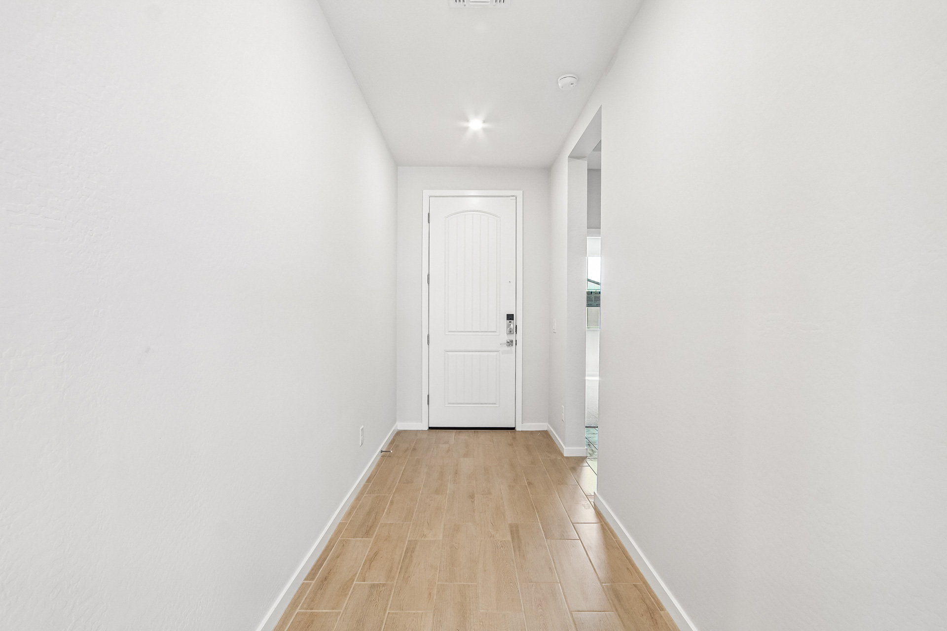 A hallway with white walls.