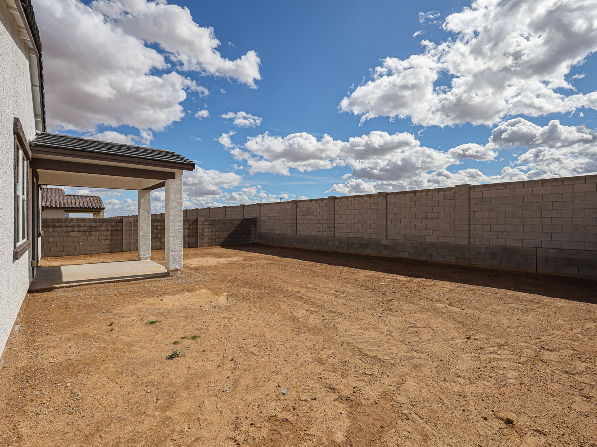 A building with a dirt field.