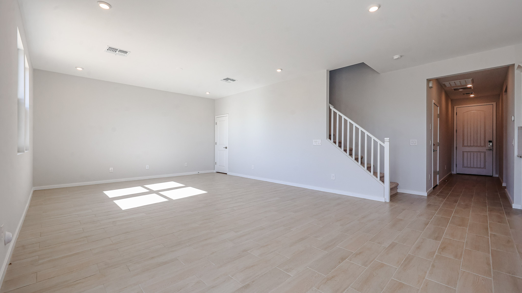 A room with a wood floor and white walls.