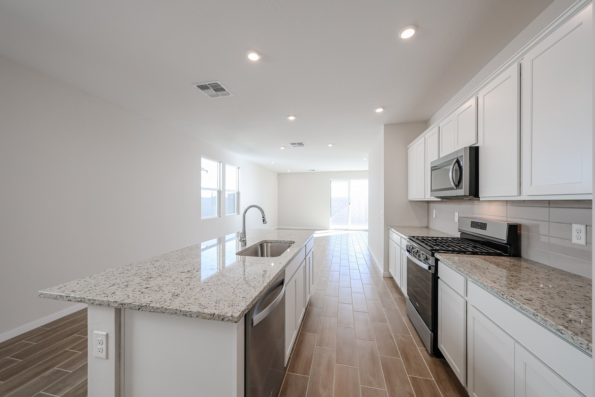 A kitchen with white cabinets.