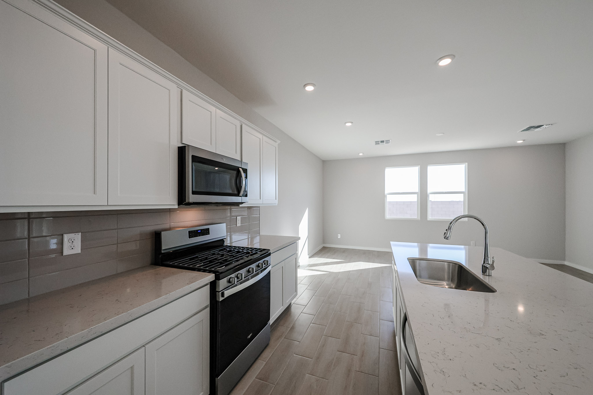A kitchen with white cabinets.
