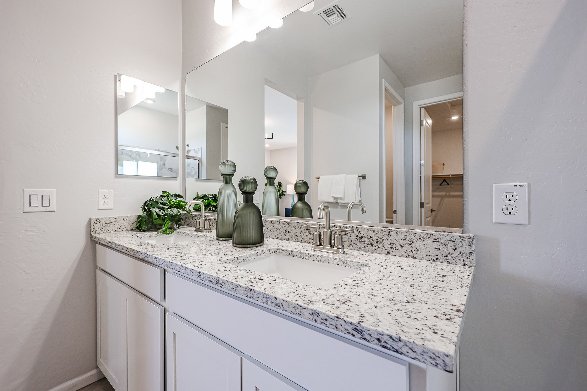 A bathroom with a large mirror.