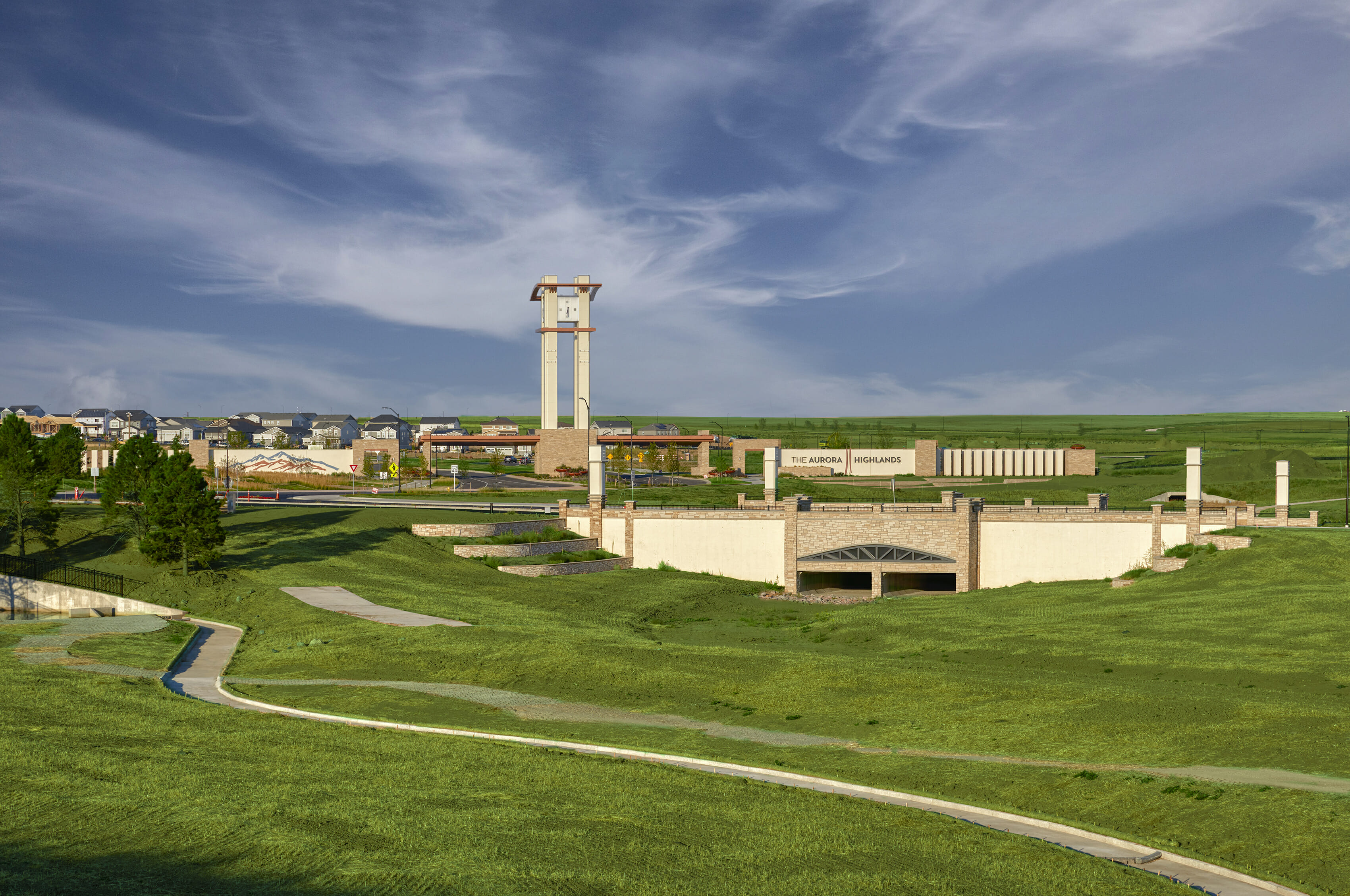 A large green field with a tower in the distance.