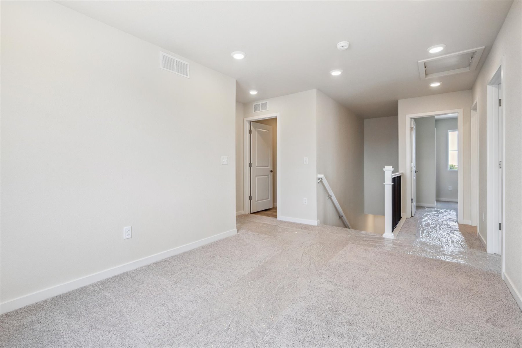 A long hallway with white walls.