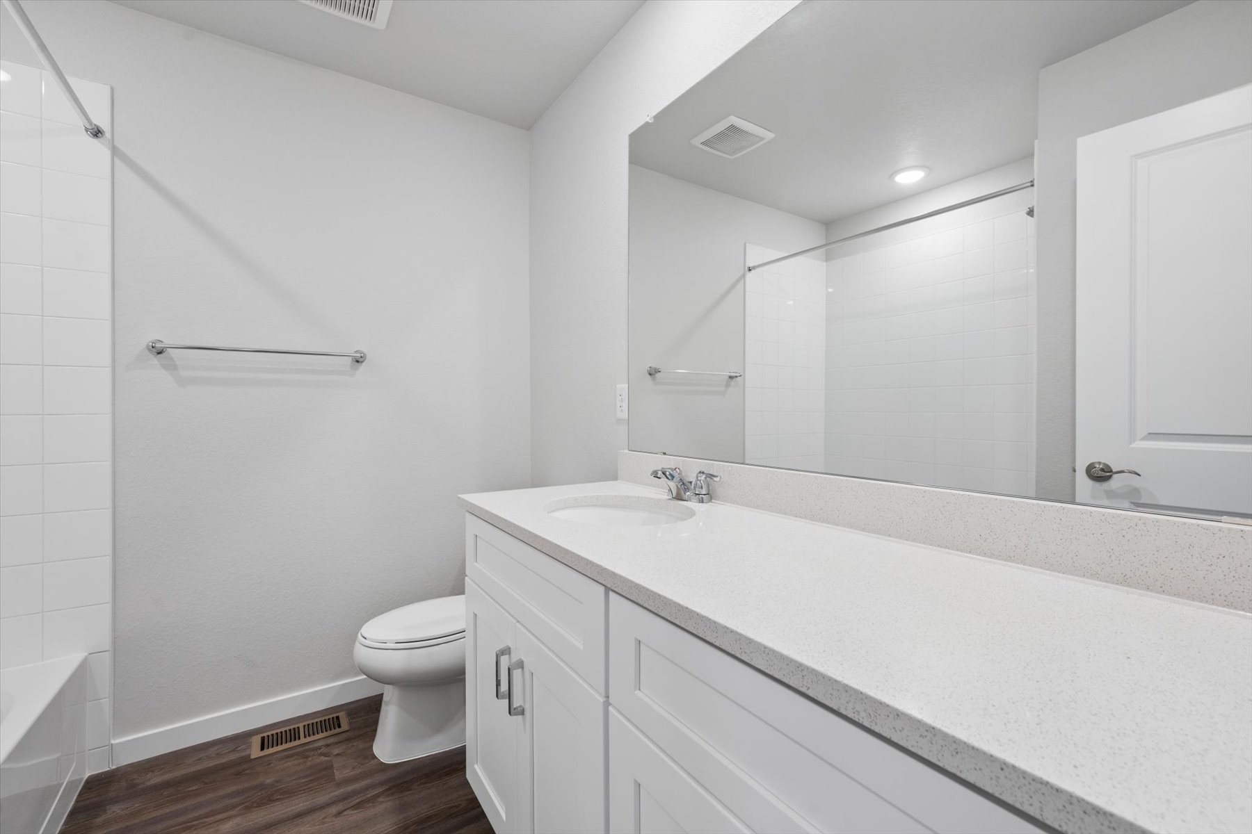 A bathroom with a tub toilet and sink.