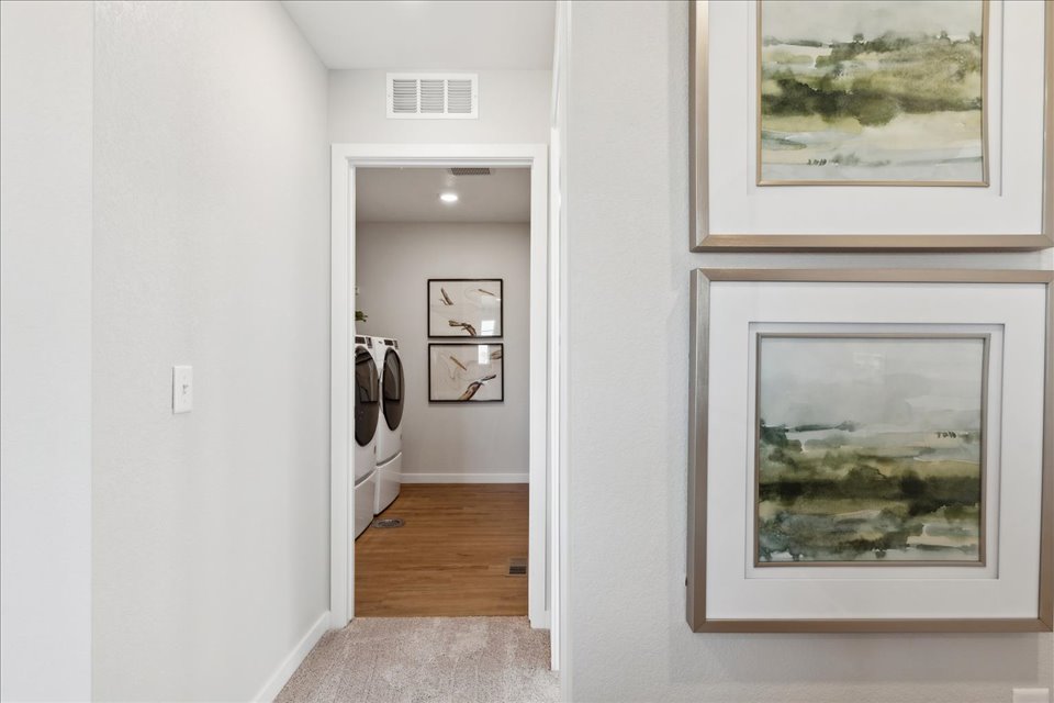 A room with a white wall and a picture frame.