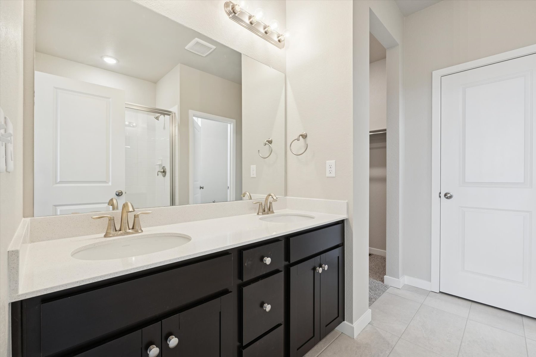 A bathroom with a large mirror.