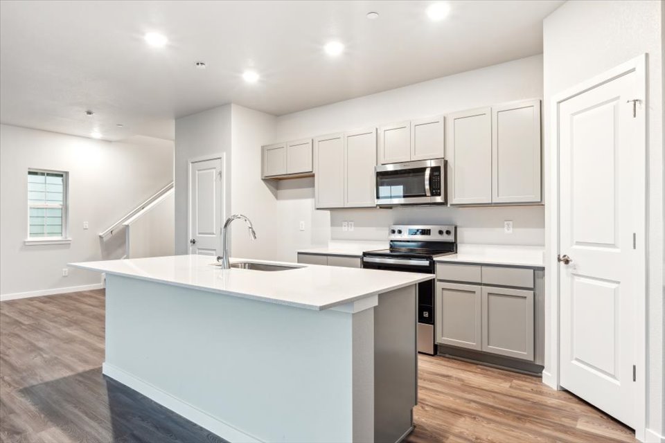 A kitchen with white cabinets.