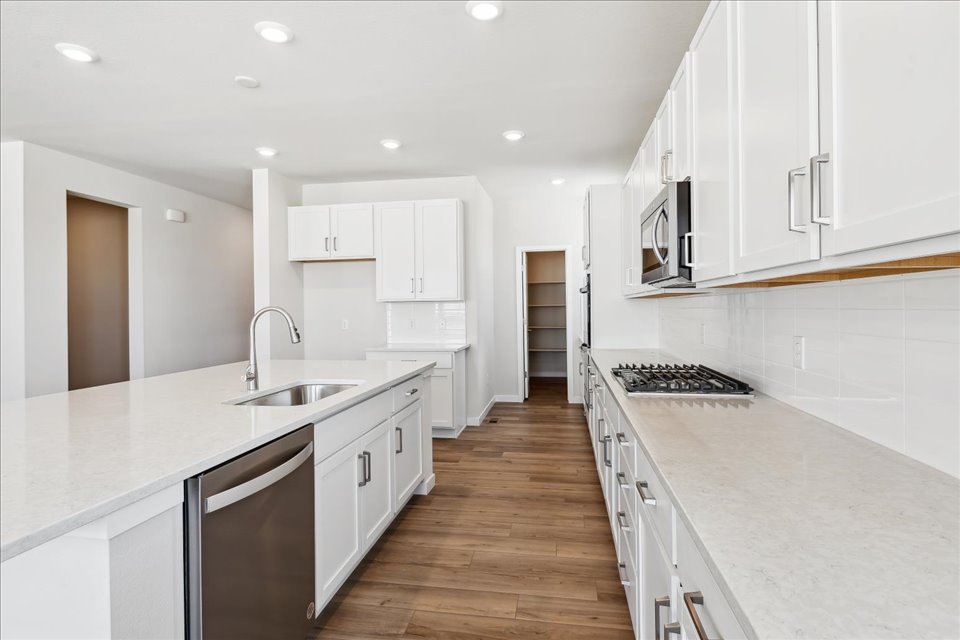 A kitchen with white cabinets.