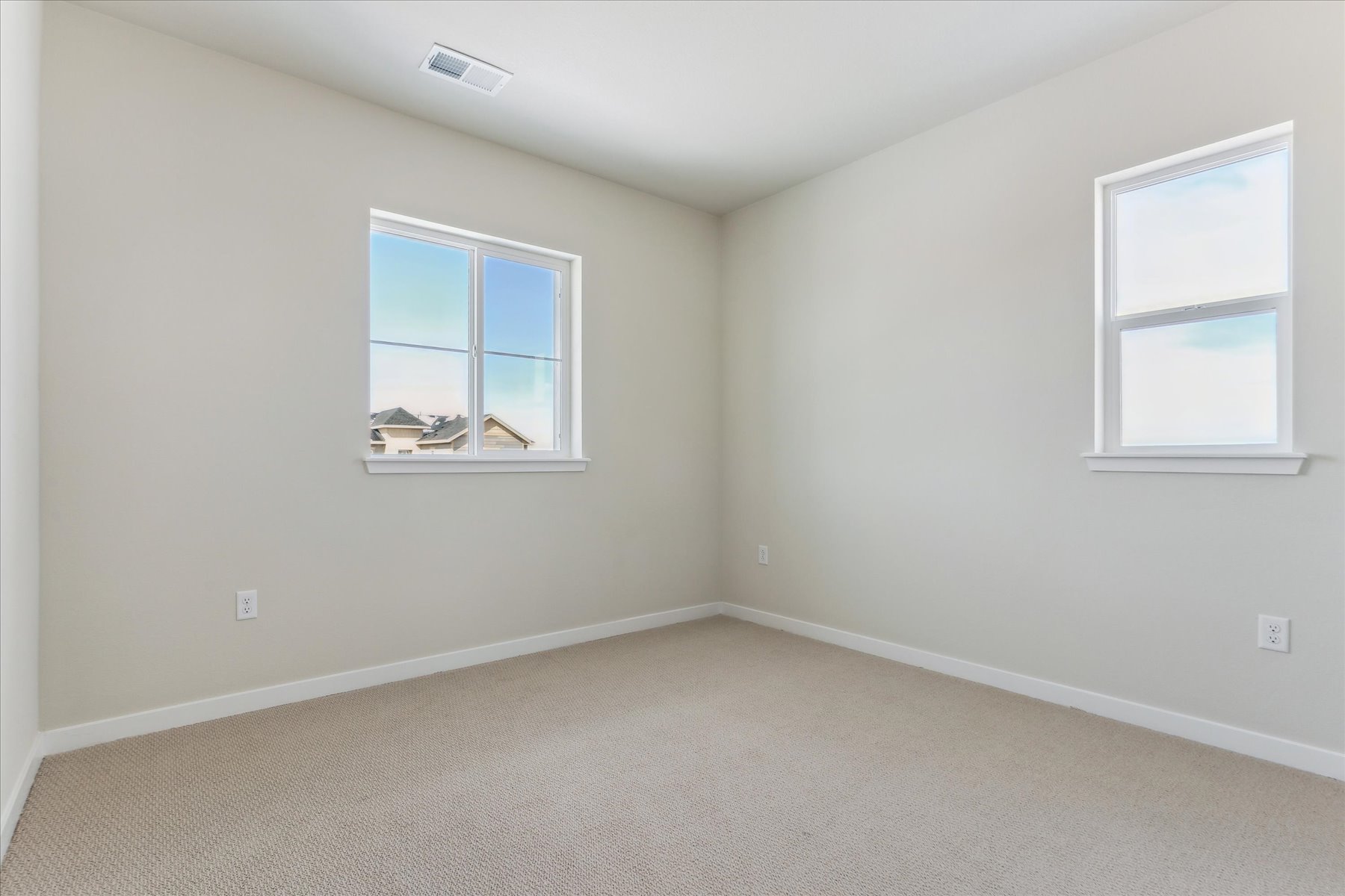 A room with a window and a carpet.