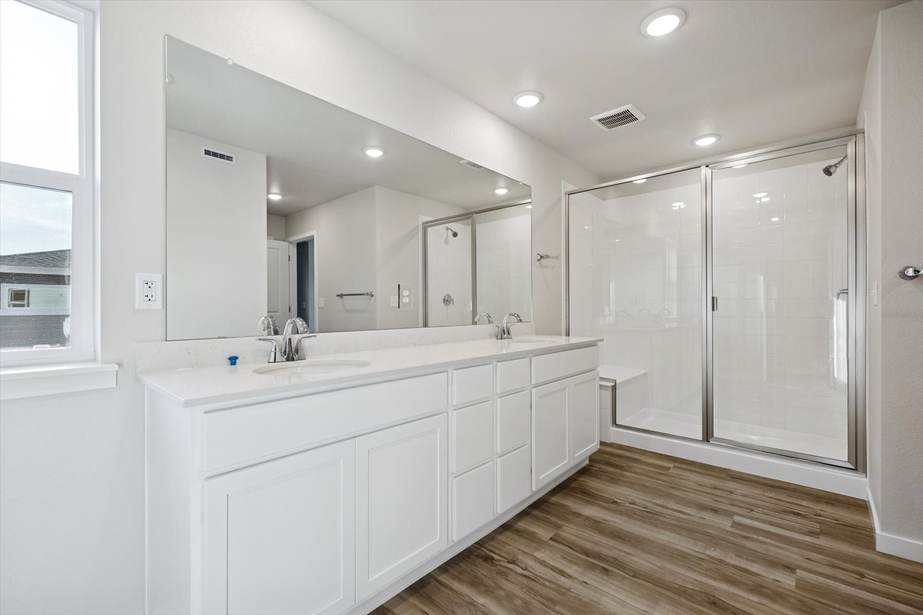 A bathroom with white cabinets.