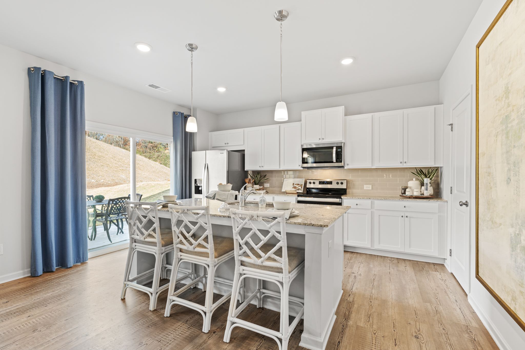A kitchen with a dining table and chairs.