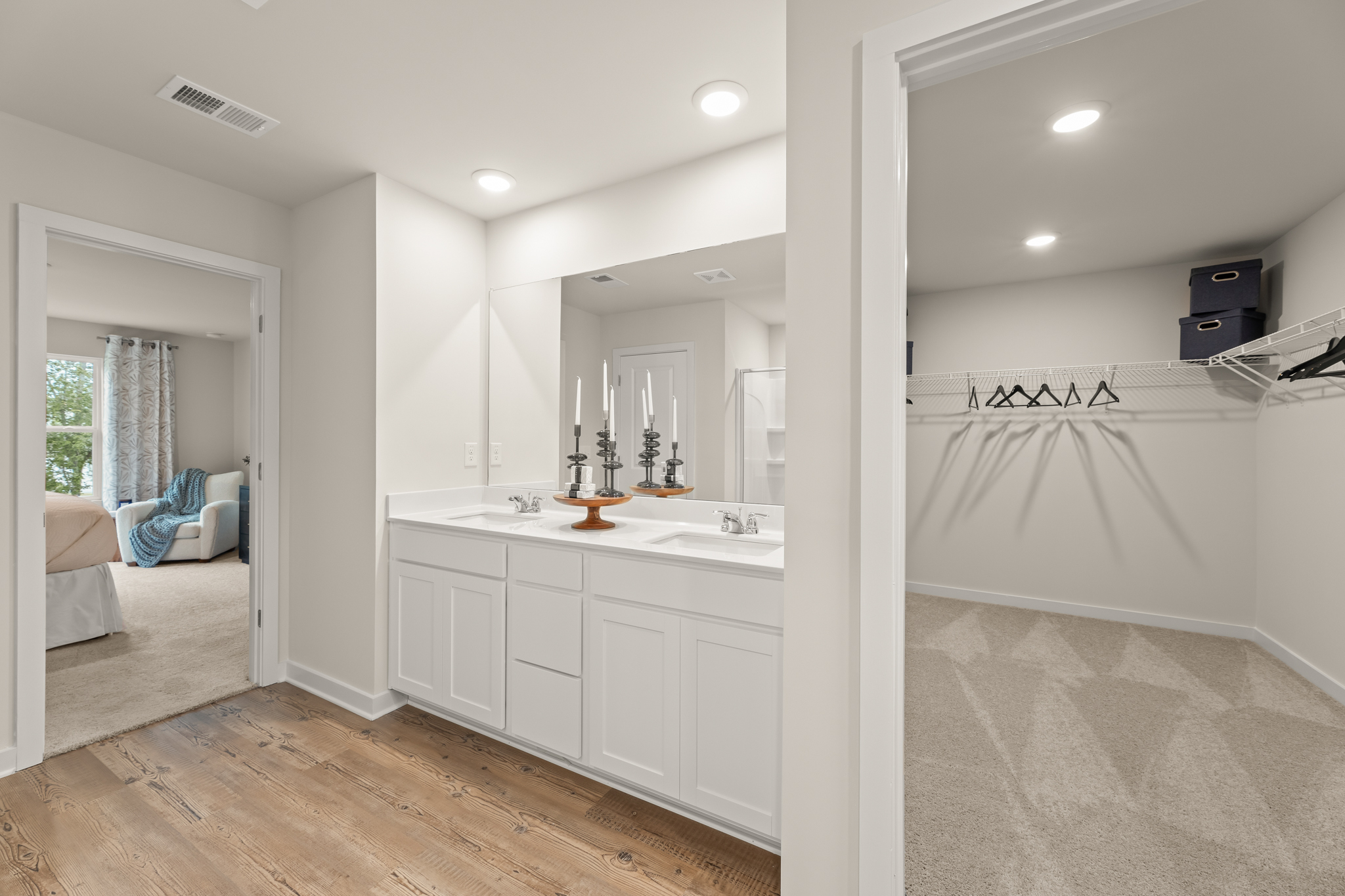 A bathroom with white cabinets.