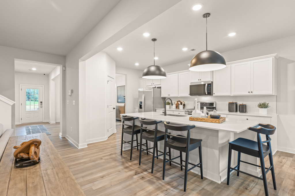 A kitchen with white cabinets.