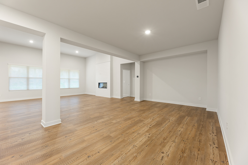 A room with a wood floor and white walls.