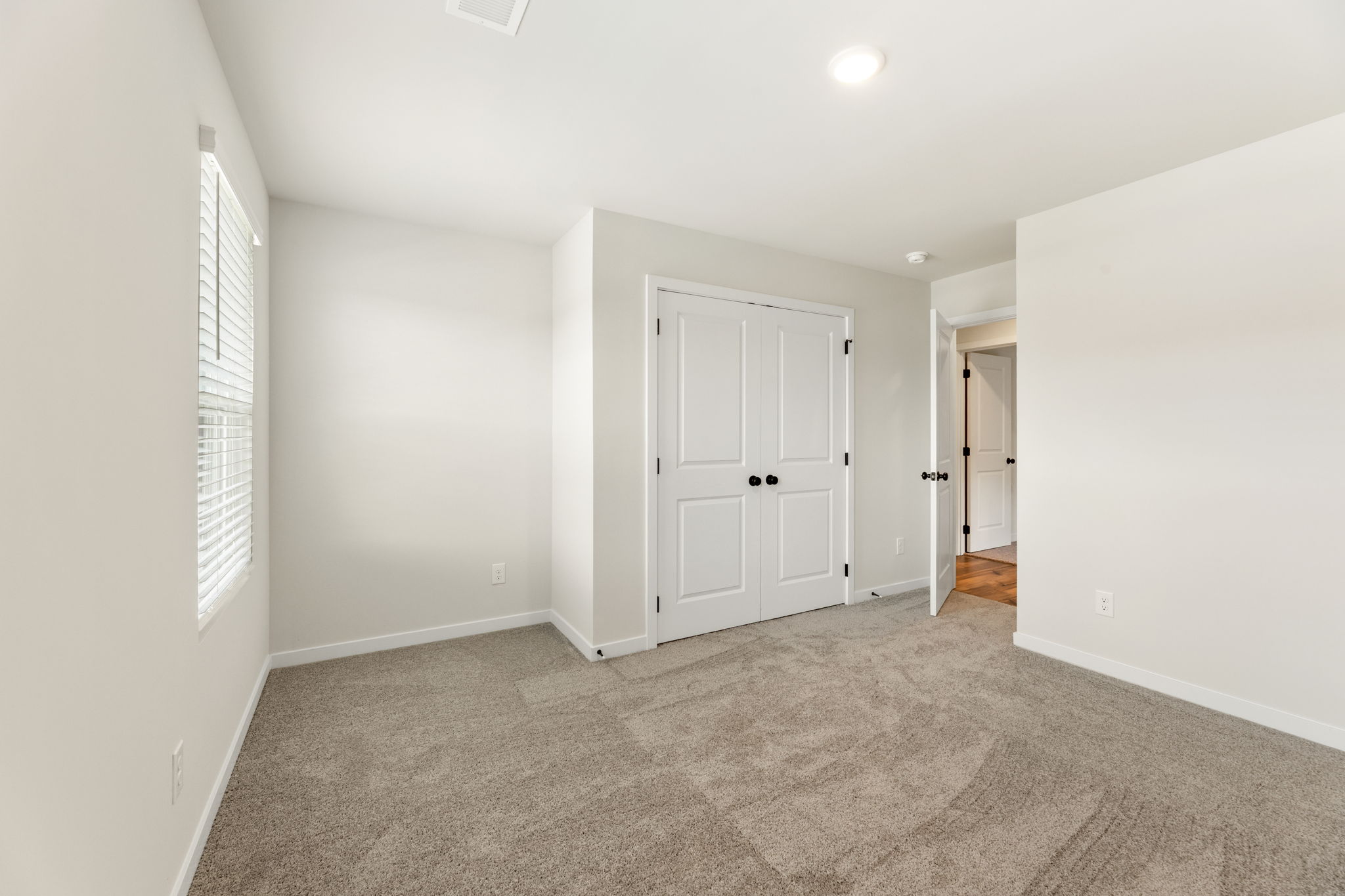 A hallway with white doors.