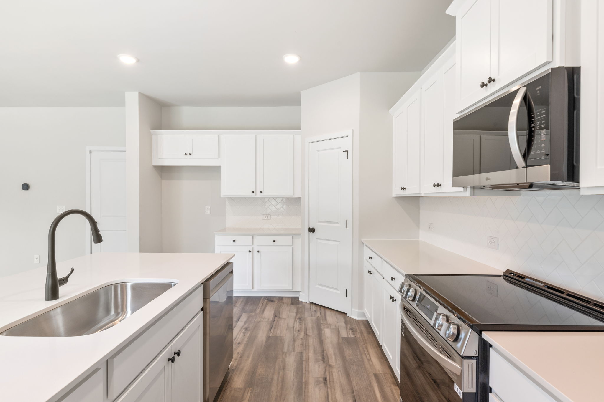A kitchen with white cabinets.