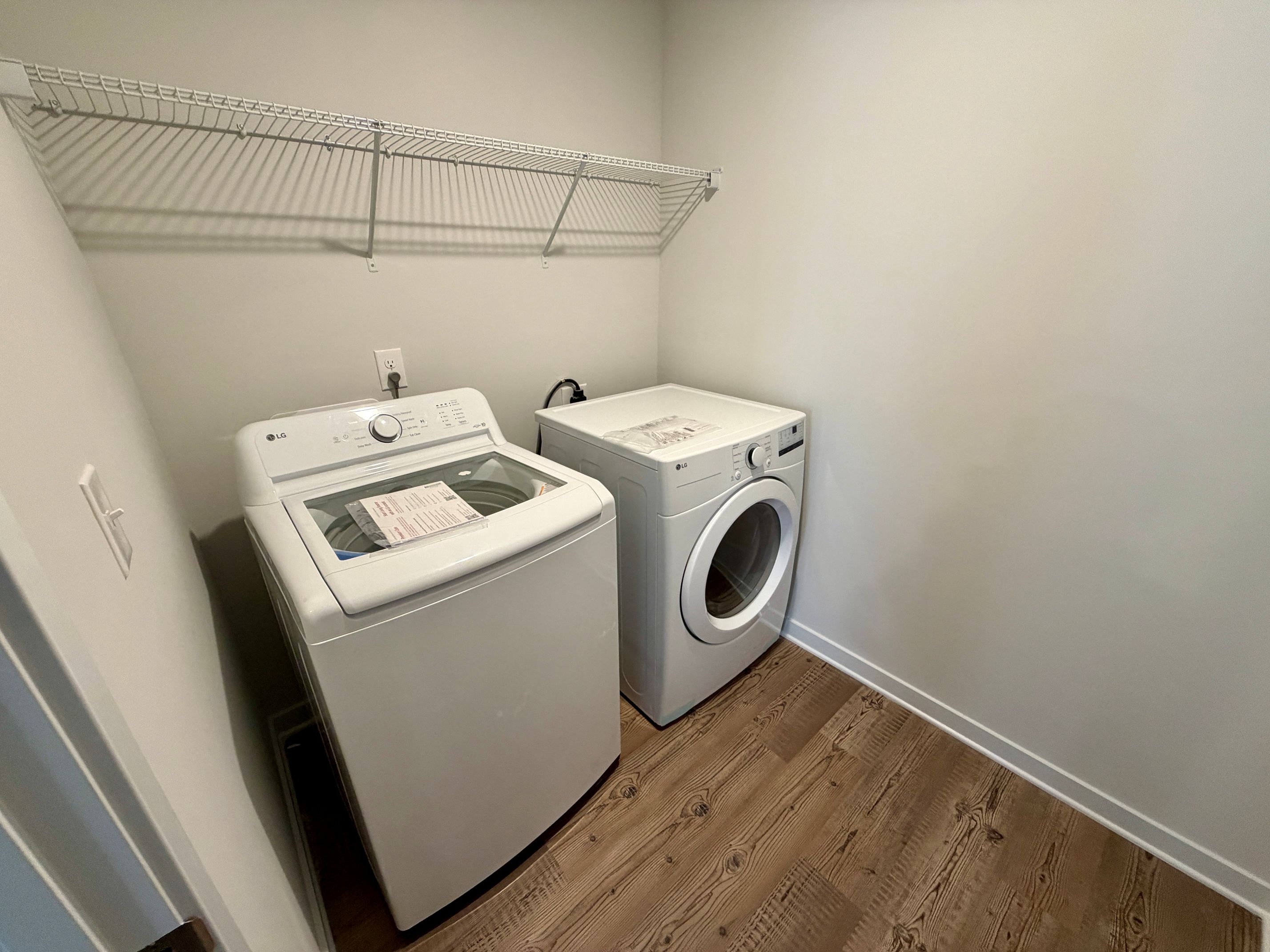A washing machine and dryer in a room.