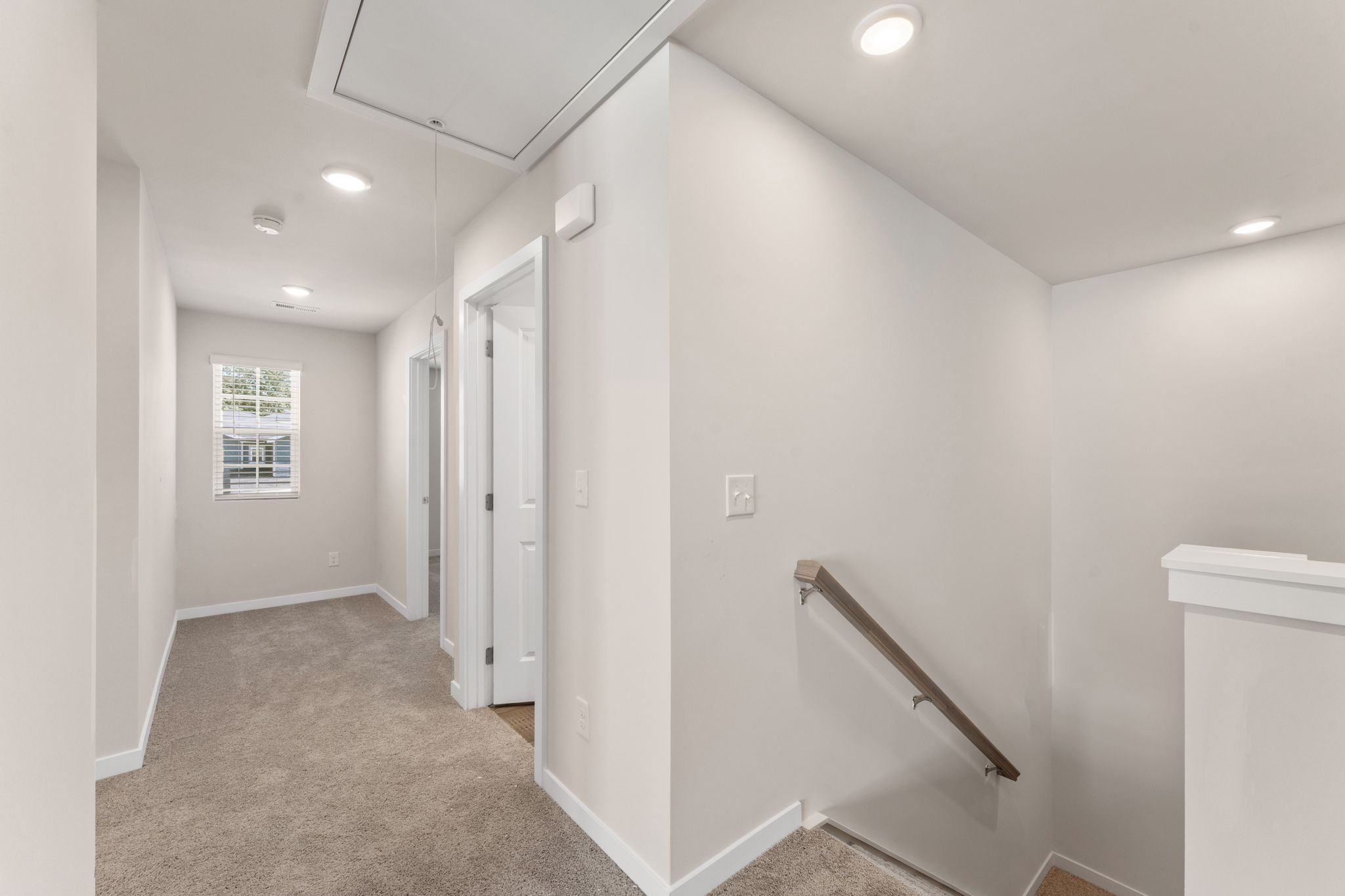 A hallway with white walls.