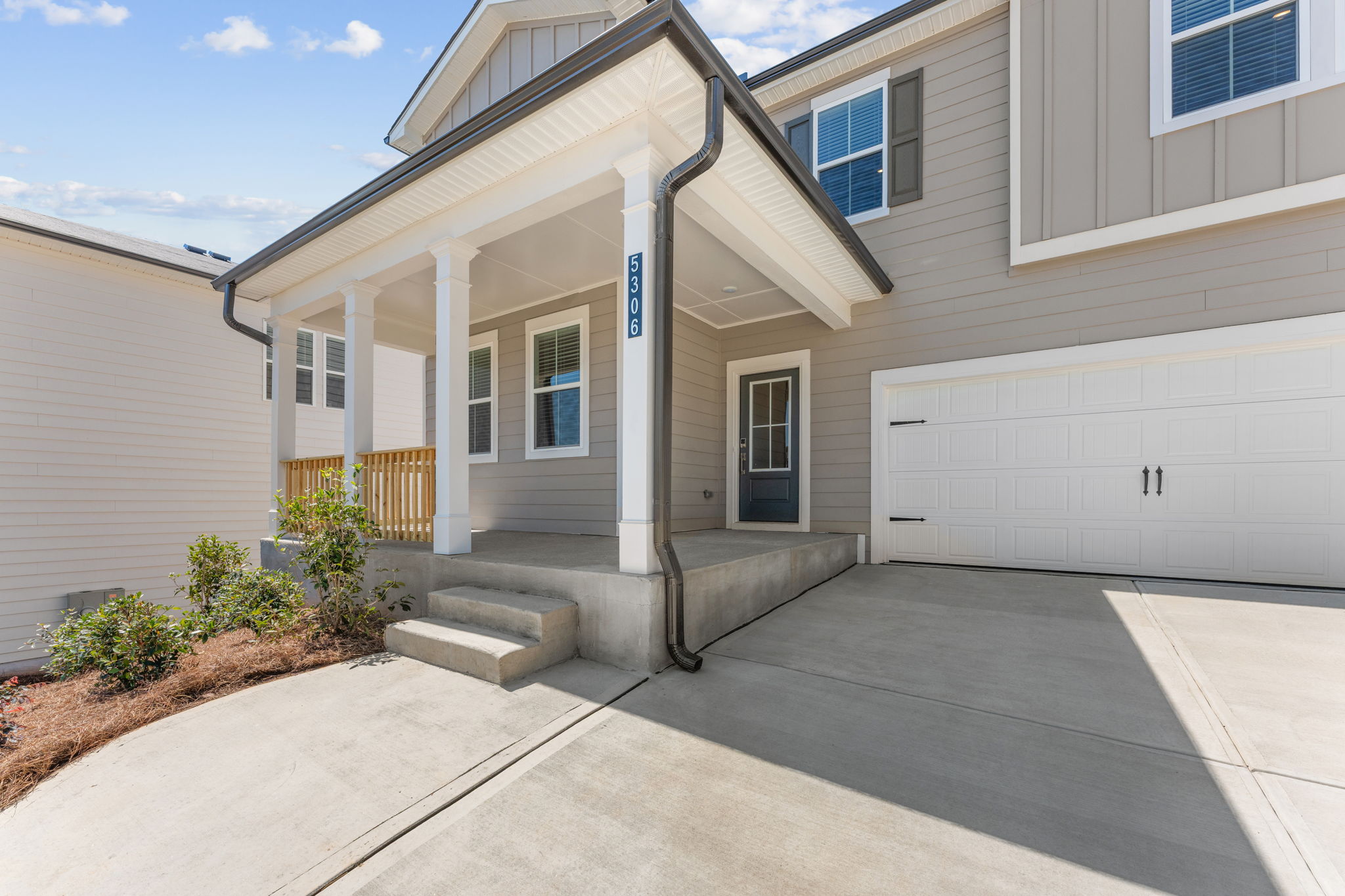 A white house with a garage.