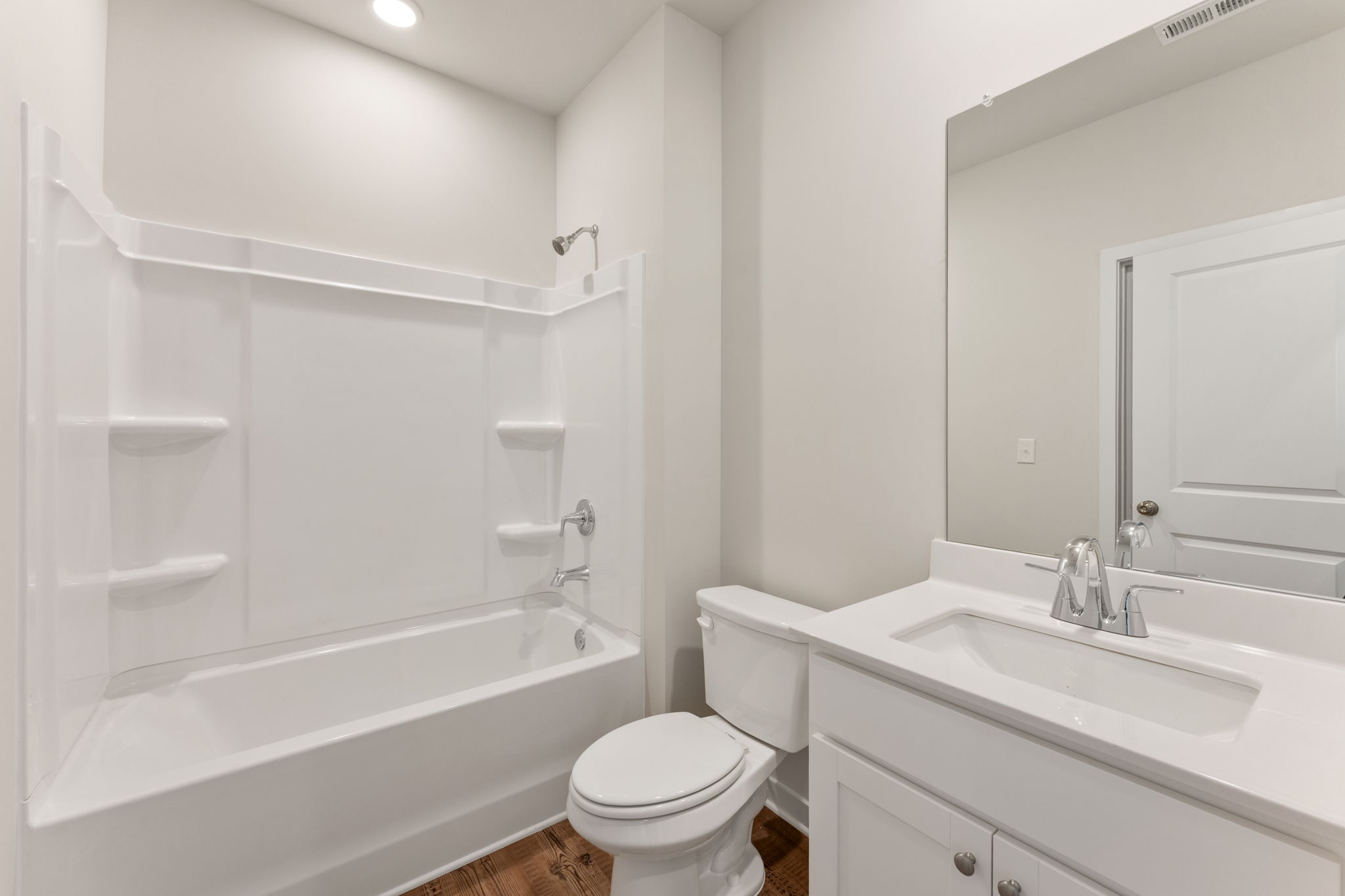 A bathroom with a tub toilet and sink.