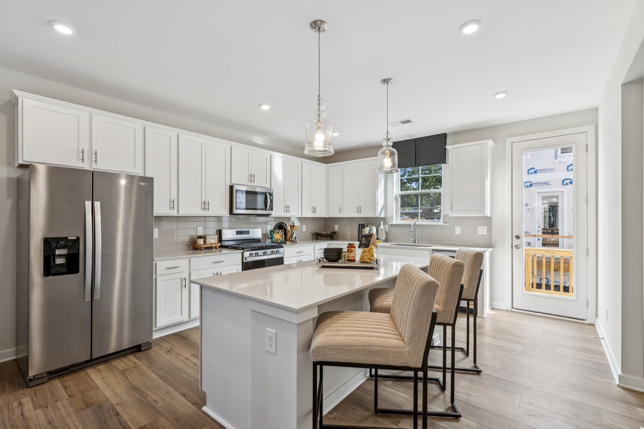 A kitchen with white cabinets.