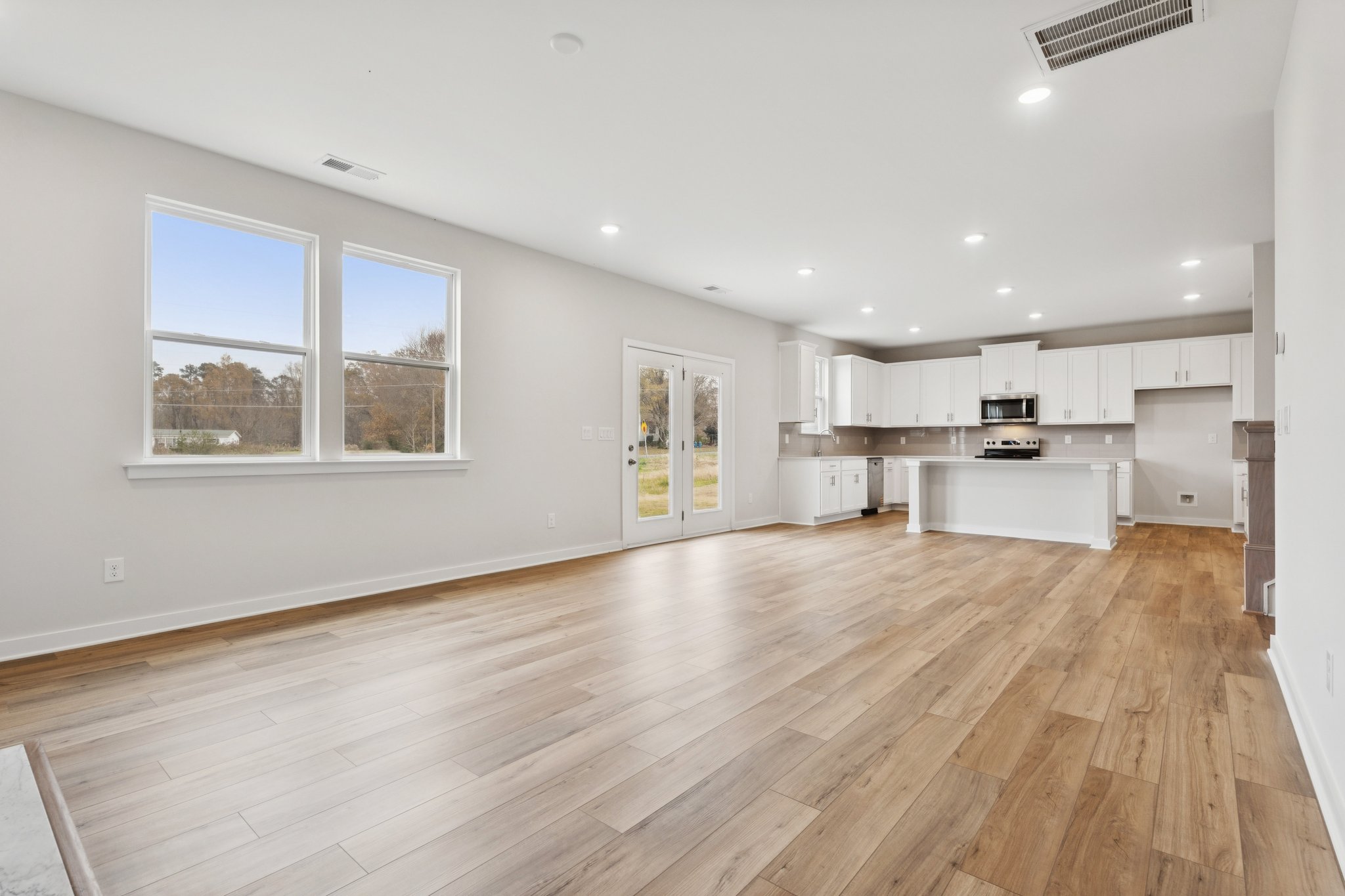 A large kitchen with white cabinets.