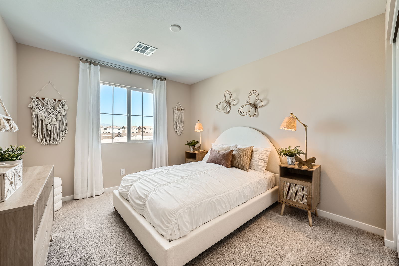 A bedroom with a bed and a window.