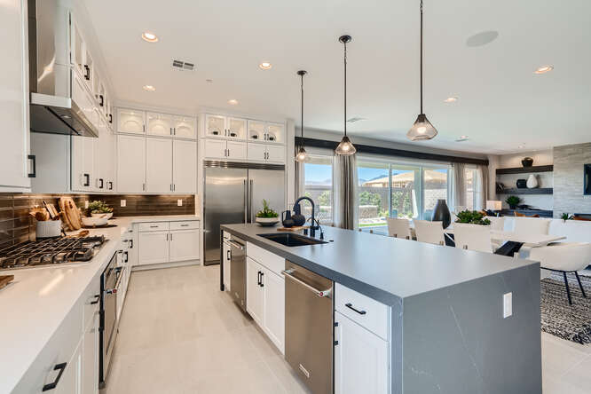 A kitchen with white cabinets.