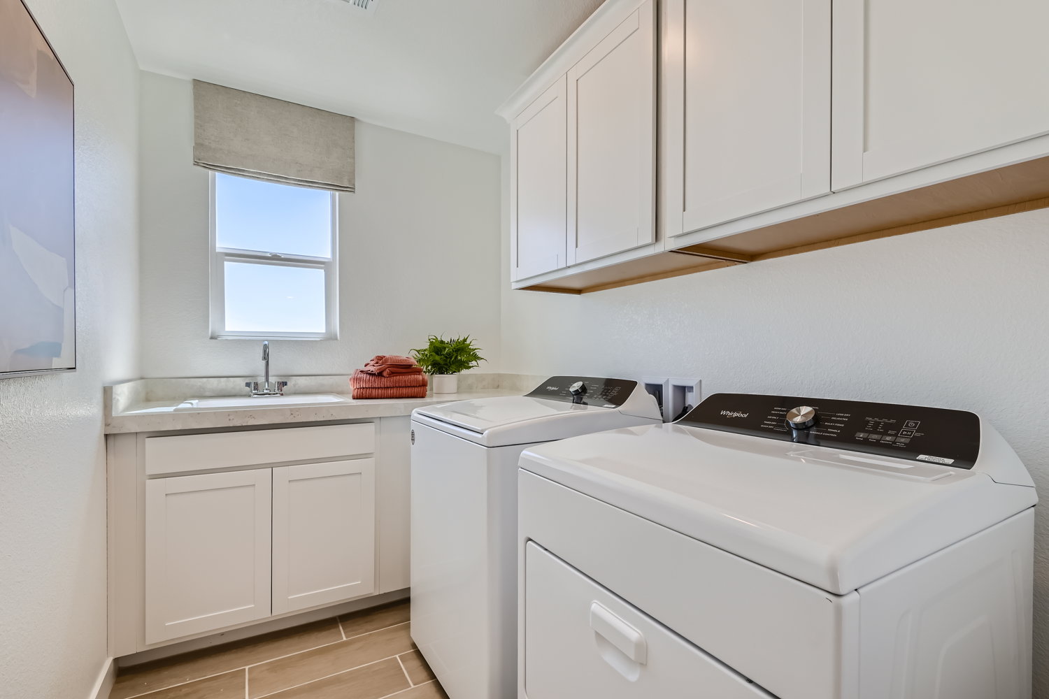 A kitchen with white cabinets.
