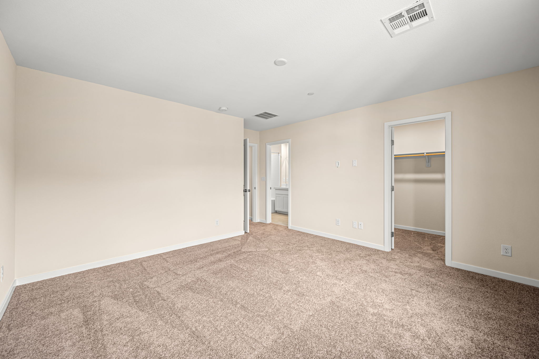 A room with carpet and a door.