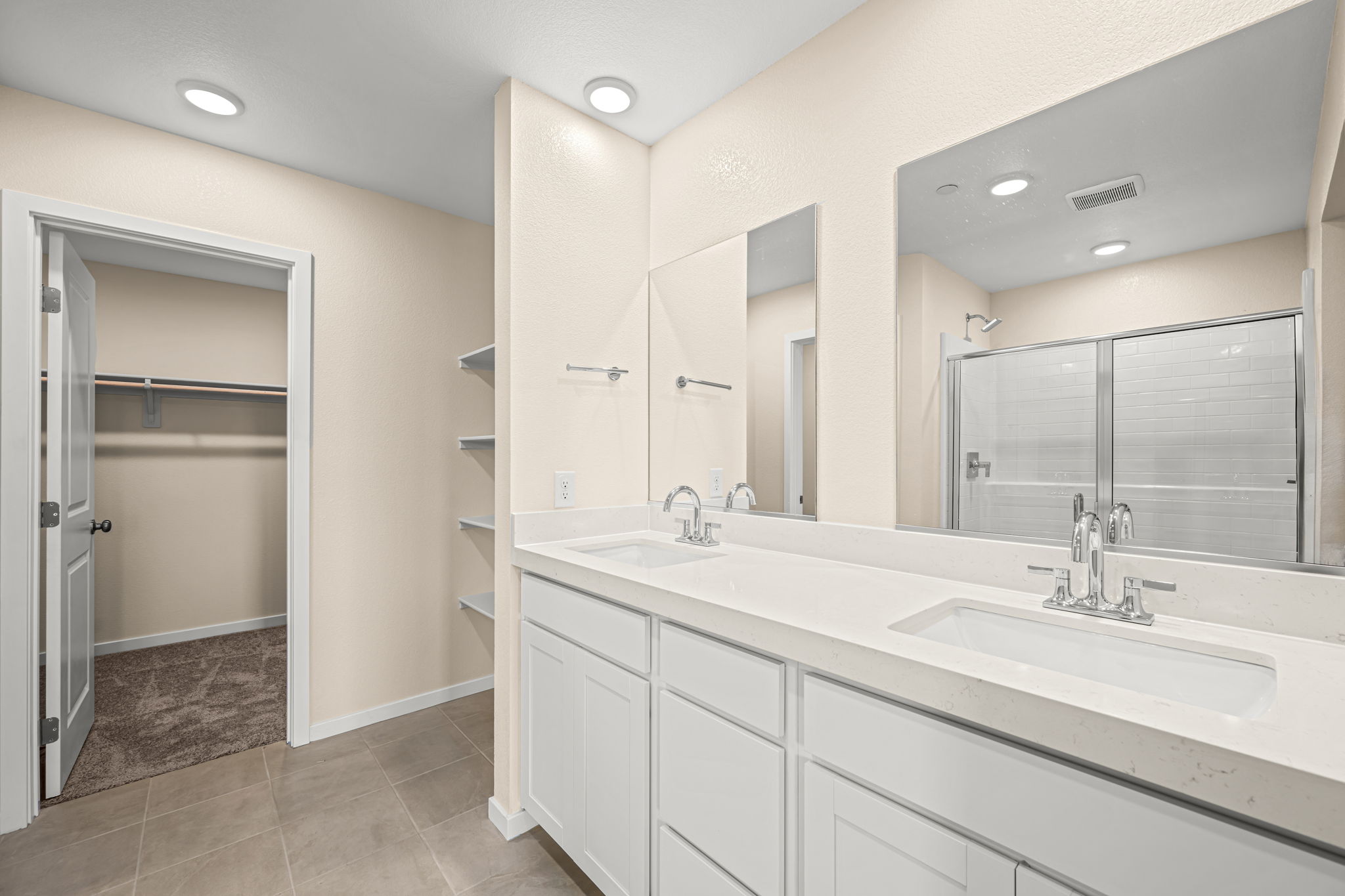 A bathroom with a large mirror.