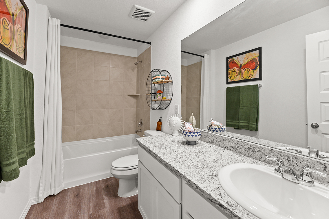 A bathroom with a marble countertop.