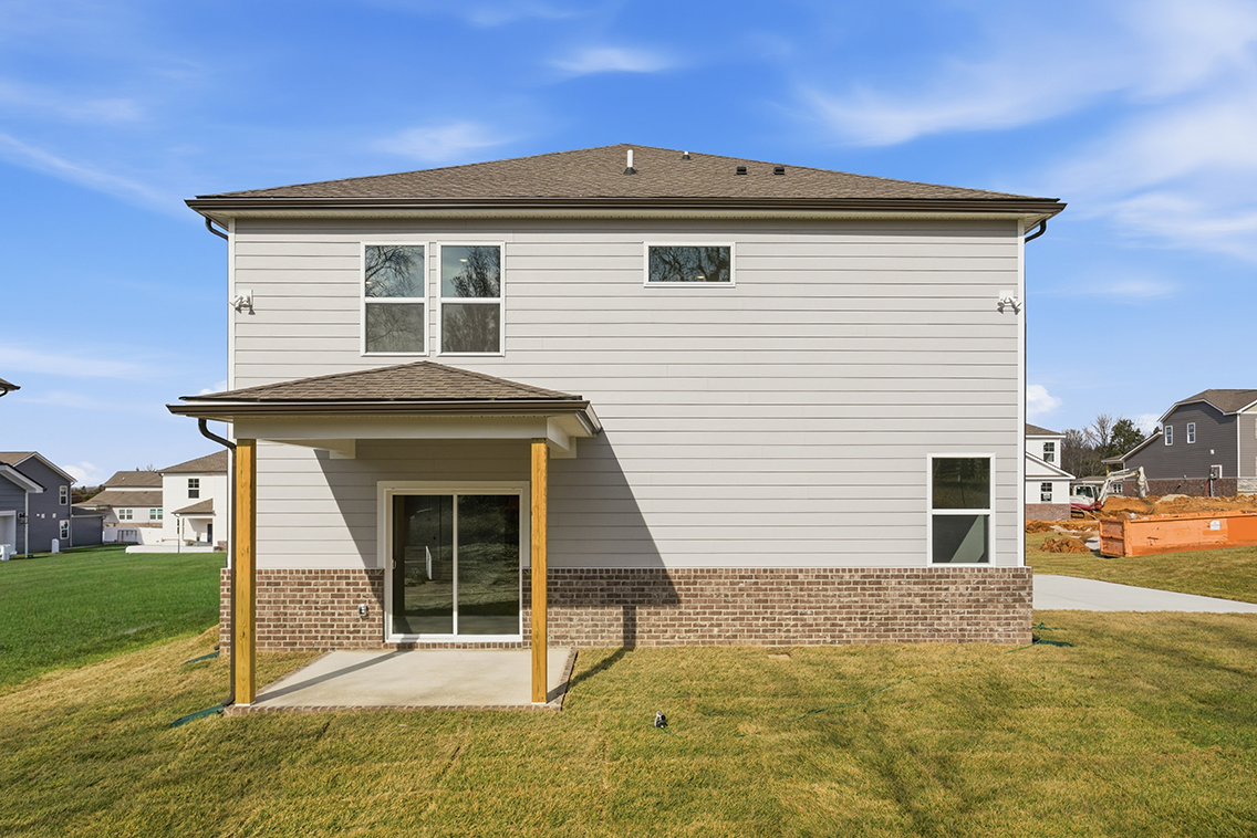 A small house with a brick wall.