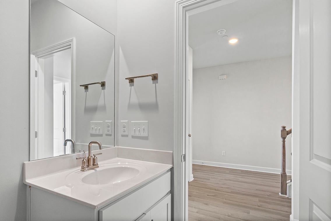 A bathroom with a large mirror.